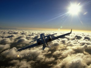 An RYL Jet soaring above the clouds